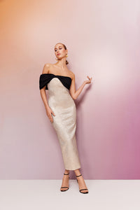 strapless tube lurex gold dress with a one shoulder black bow detail 